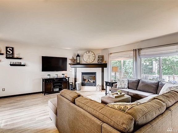Lots of windows offer great natural lighting, and enjoy the cozy gas fireplace.