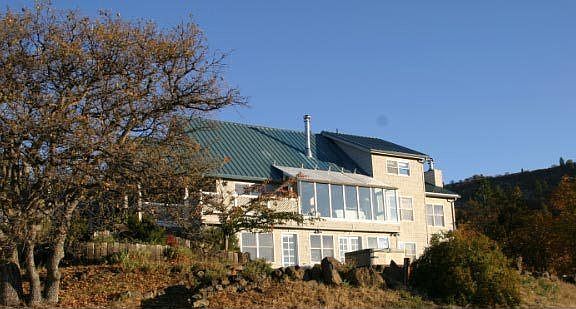 View of elegant home from the inground pool. 
