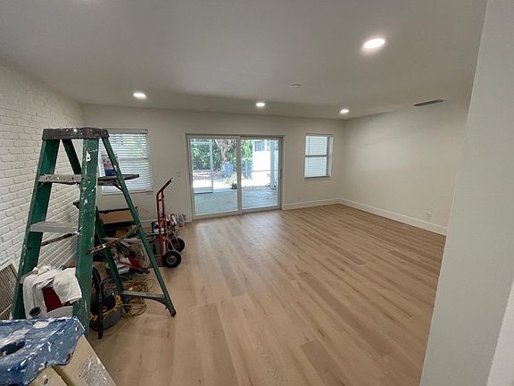 Large living room (14'8" X 21' ) new impact sliders leading out to generous sized screen patio.(11'9" X 24') Overlooks green space in private rear yard.