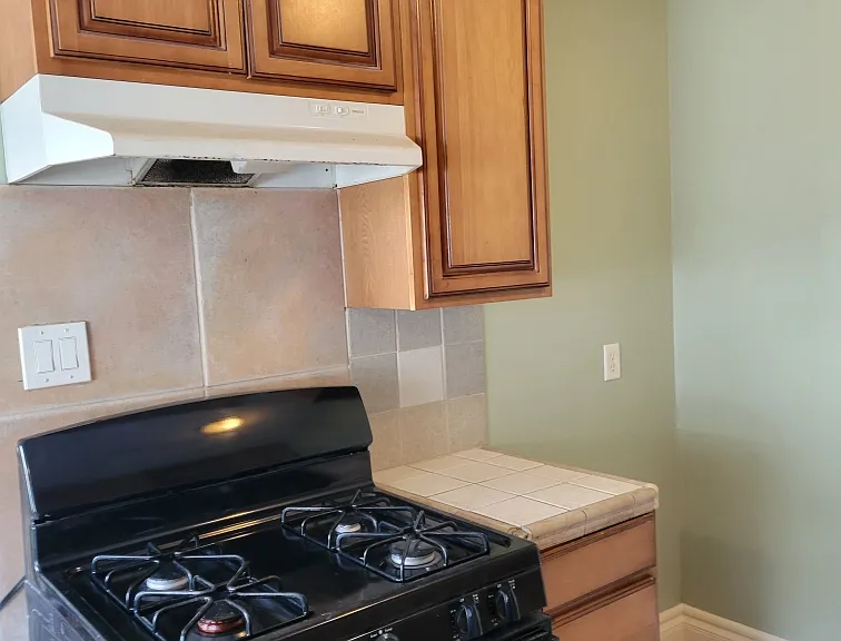 Showing the stove and cabinets before the new microwave was installed