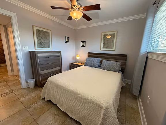 Two bedrooms furnished with queen beds and bedding