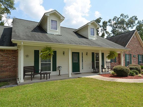 What more than a front porch to rock your worries away. Wonderful extensive landscaping has been done so it is as pretty outside as inside.