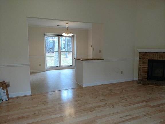 View from living room into dining area and kitchen. Maple laminate floors in all areas except kitchen and baths.