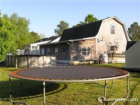 view across the back yard, pool, hot tub. .