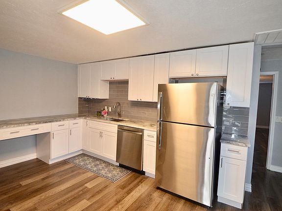 Brand new kitchen has granite countertops, new cabinets, backsplash and stainless appliances.