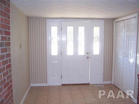 LARGE ENTRY FOYER WITH DOUBLE COAT CLOSET AND CERAMIC TILED FLOOR.