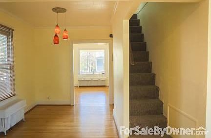 Dining room and living room
						:
						Bright living room has a large picture window that looks out onto the porch.
