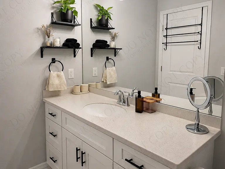 This well-appointed bathroom features a clean, contemporary design with a spacious vanity, sleek modern fixtures, and ample storage. Its bright, organized layout provides a fresh and functional space that complements the rest of the apartment