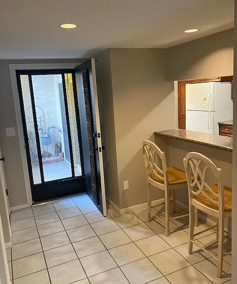 Front door entry with screen door.