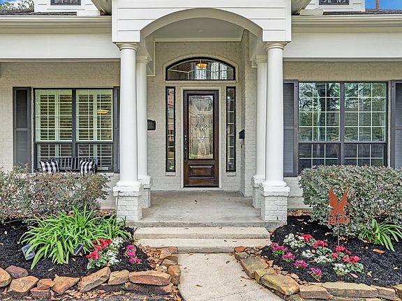 [Front Entrance]The graceful portico entry leads to the wide front porch and leaded glass door and side lights