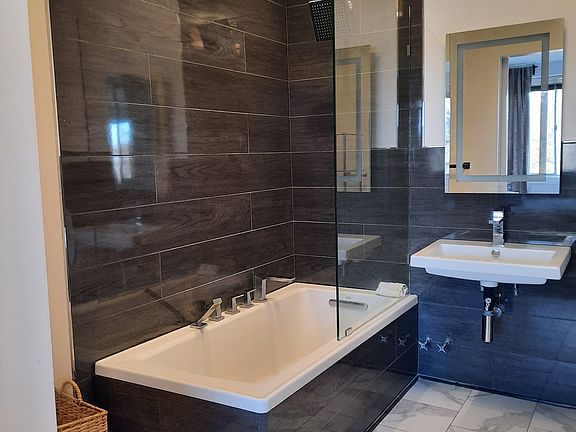 Beautiful spa like bathroom with great soaking tub. Barn door access from bedroom.