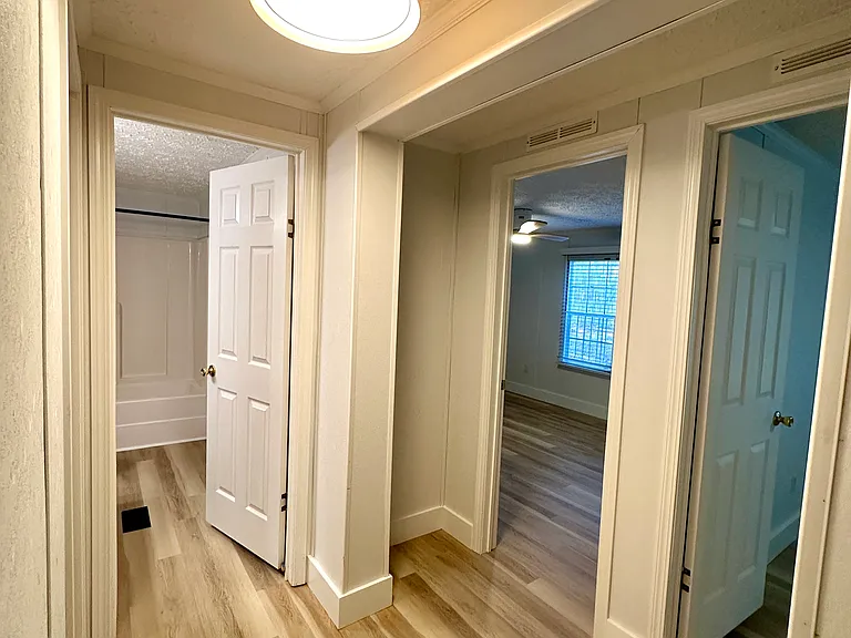 Hallway bath and two bedrooms with closets