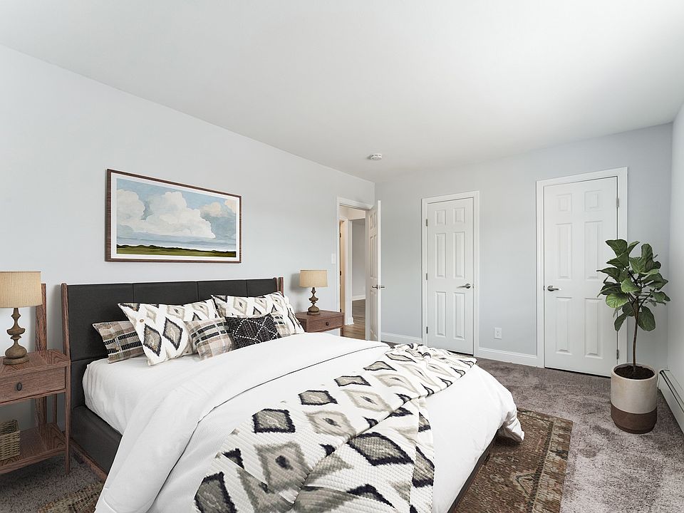 Step into comfort at Mid Island Apartments. This spacious bedroom features modern decor, ample storage, and a serene atmosphere, perfect for relaxation. Elevate your living experienceschedule your visit today!