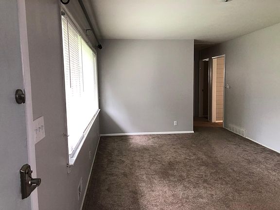 Spacious front living room with large picture window.