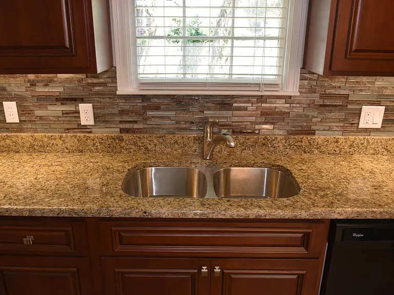 Stainless steel sink, Moen faucet w/sprayer, granite counters, multiple outlets.