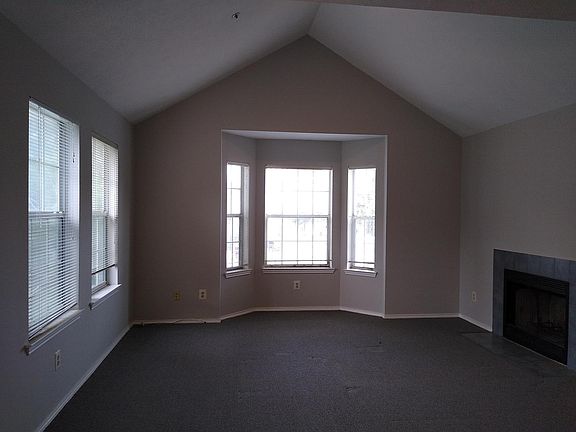 Spacious living room with high ceiling and bay window