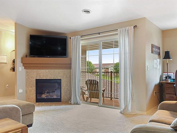 Expansive living room features a gas fire place and tons of architectural details!