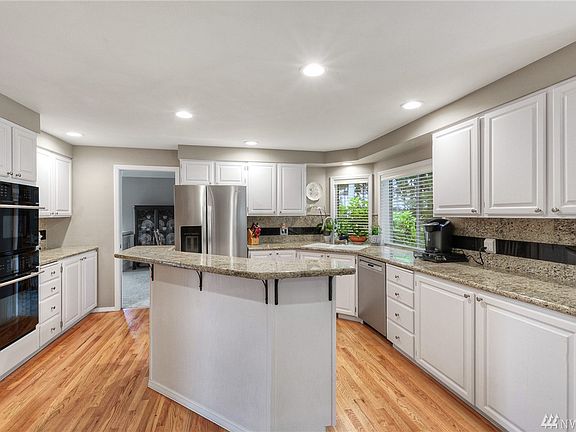 Updated kitchen with gas cook top, updated appliances and slab granite counters. Nicely refinished hardwood floors.