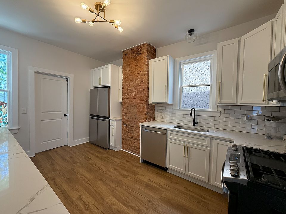 Kitchen with door to large private laundry room