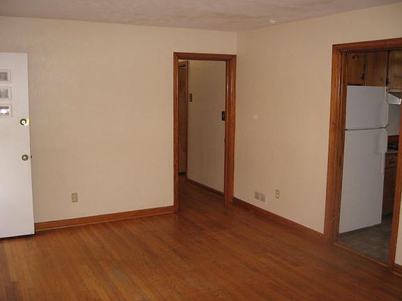 Living room. The door in the right of the picture enters the kitchen and adjacent family room The door in the middle leads down a hallway to the bedrooms and bathrooms.