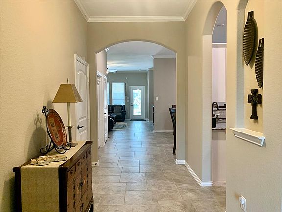 As you enter the home, you will appreciate the curved archways and art niches throughout. The upgraded floor tile is a beautiful pinwheel pattern and runs throughout the house except for the bedrooms.