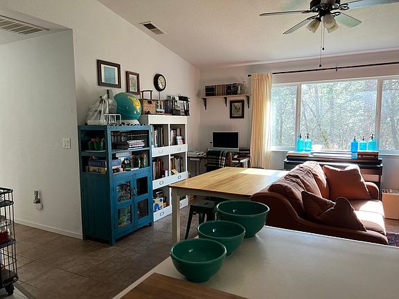 View of living space from kitchen, hallway to bedrooms on left