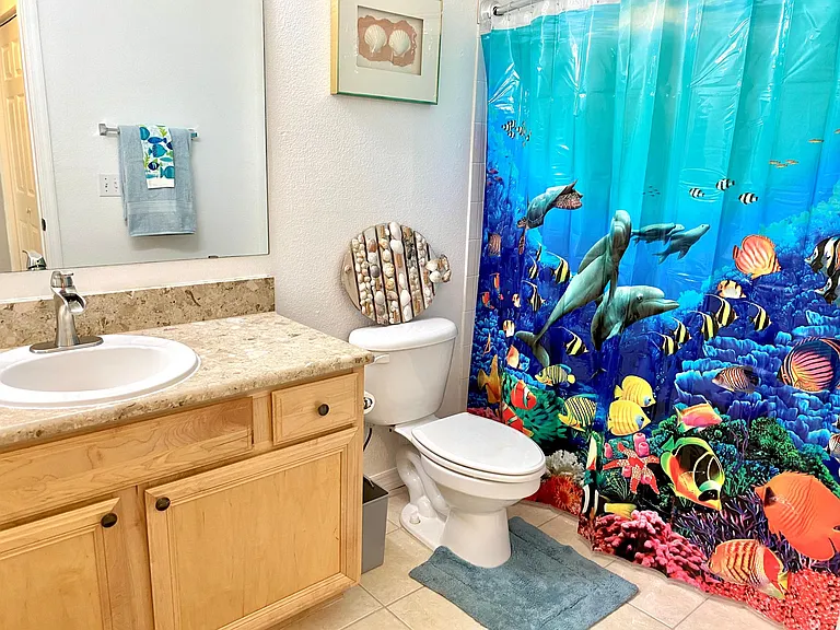 Guest bathroom has full ceramic tub/shower