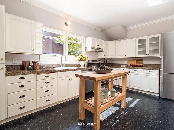 Kitchen boasts updated appliances and ample storage space.
