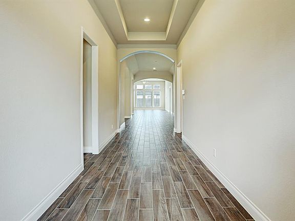 View walking in the front door. Love the wood tiles.