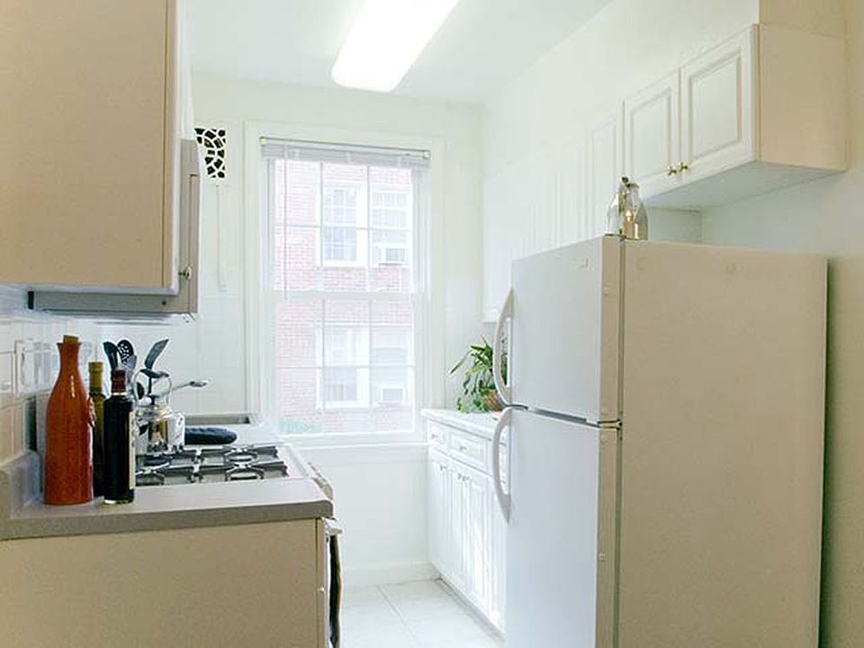 Kitchen with white cabinetry and appliances