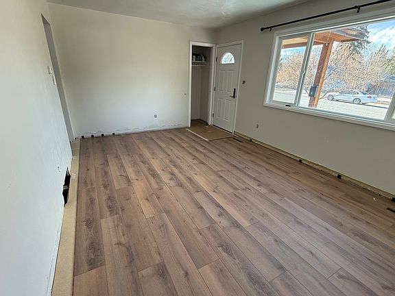 Cozy family room with a coat closet next to the front door. Brand new flooring and great view of S mountain. (Pic during renovations)
