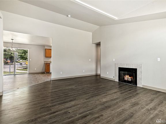 Airy vaulted ceilings adds an abundant sense of space, while the fireplace keeps it cozy. 