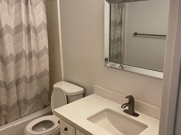 Newer sink, counters, lighting and toilet