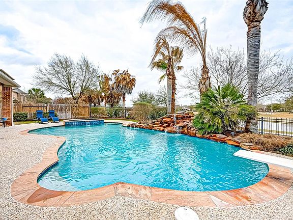 The serene feeling and relaxation is priceless! Waterfall, palm tress and invinting blue pool will make you the envy of the neighborhood!