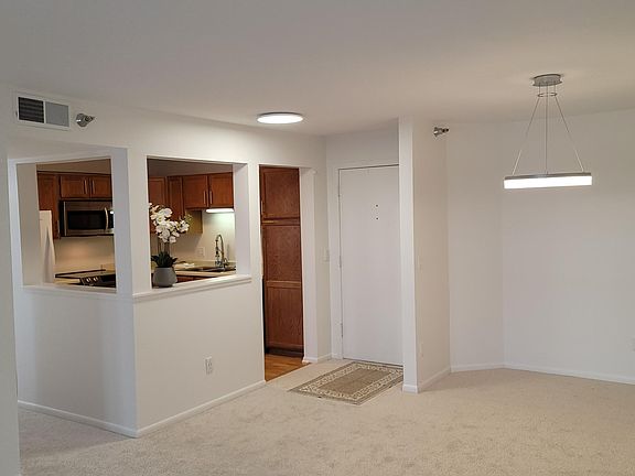 Dining room, condo entrance door, and kitchen.