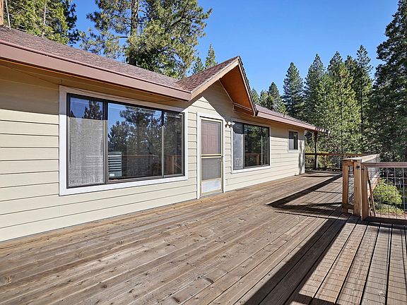 Upper floor view towards house from large balcony/deck