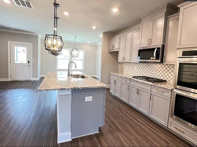 Kitchen with white luxury cabinets and granite island