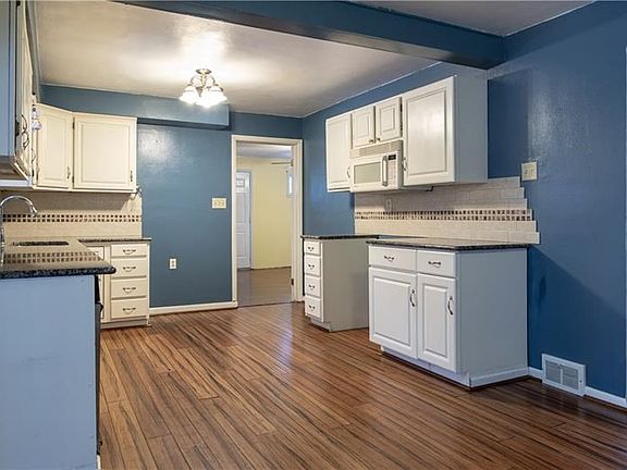 The large eat-in kitchen feature new granite countertops and a finely tiled backsplash. There is even room to add an island for 