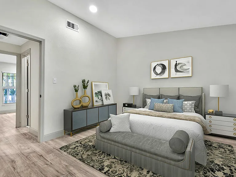 Luxurious bedroom with elegant decor, featuring a plush bed, stylish furniture, and soft lighting.