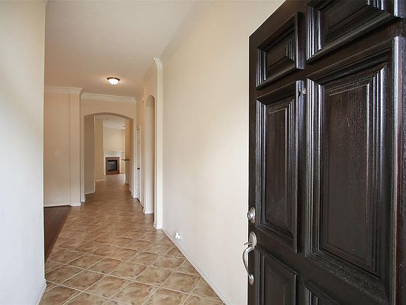 Welcoming Entry with high ceiling and tile floors