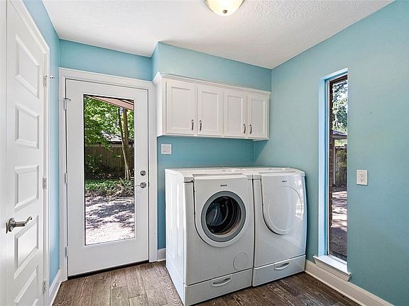 Large utility room comes with the washer and dryer shown, access to the half bathroom, and plenty of space for a mudroom bench!