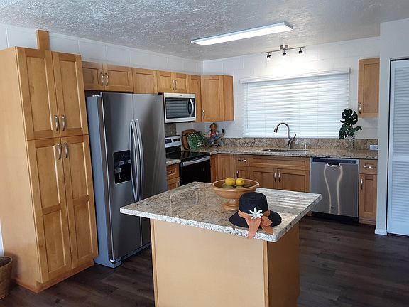 Expanded kitchen has new appliances, pantry and island with extra seating
