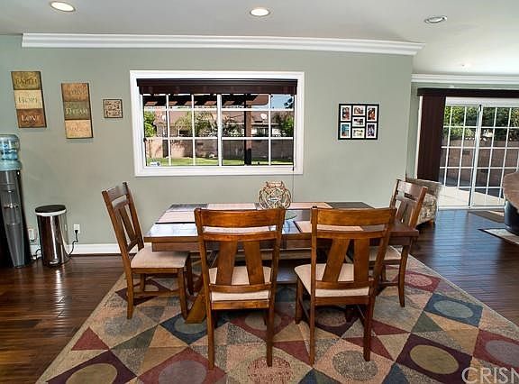 The large dining area with recessed lighting and crown moldings.