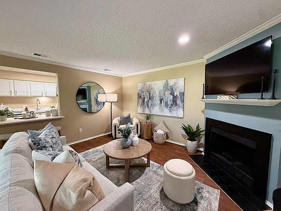 Spacious living room with hardwood-style flooring & fireplace