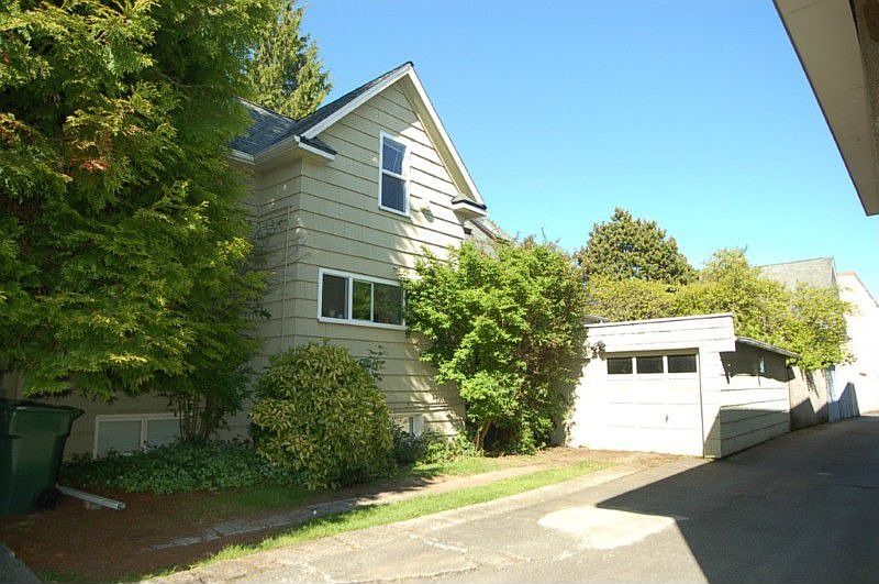 Parking for 2 and a garage. Garage belongs to the main floor unit #1. Rear garage access goes to rear yard and porch for unit #1. New Siding on South wall, and roofing of house and garage installed 2010.