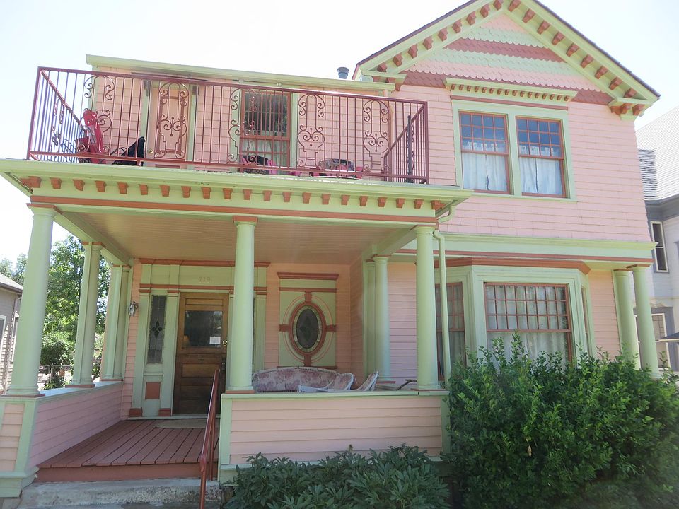 Front of house. The apartment is on the right with the bay window