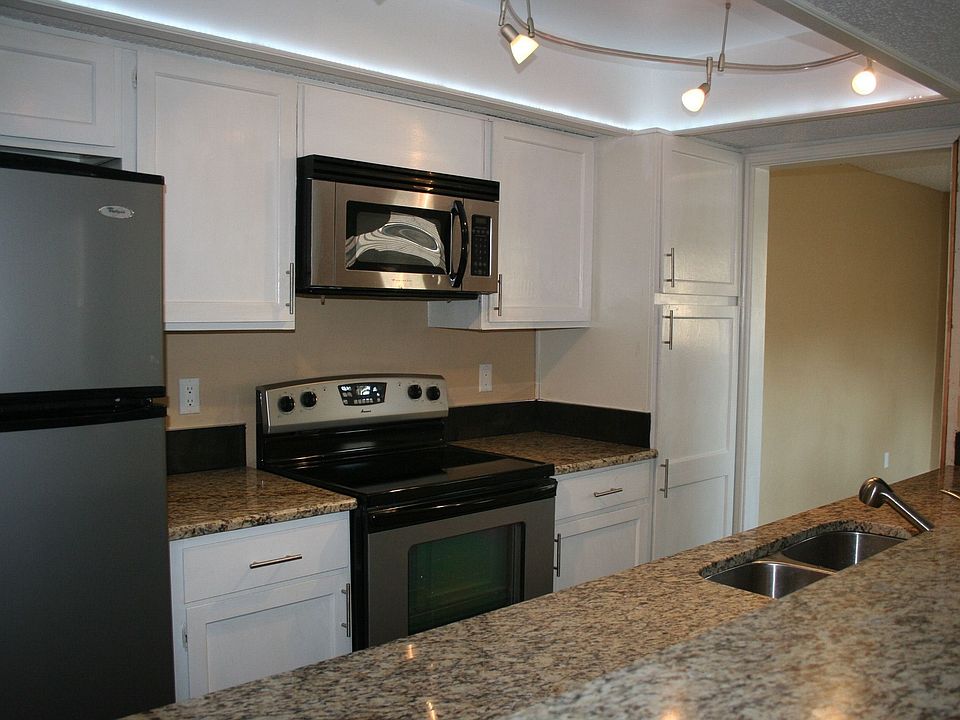 Kitchen with all stainless, granite, cool lighting. 