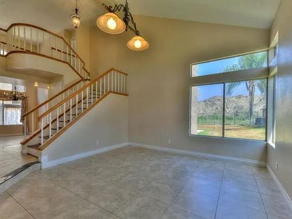 Formal living/sitting room with adjacent winding staircase connecting to the second floor bedrooms.