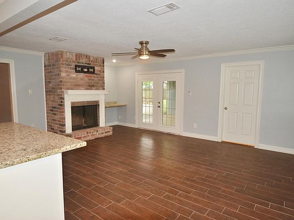 Double french doors lead to covered patio and fenced in backyard. Laundry room door on right.