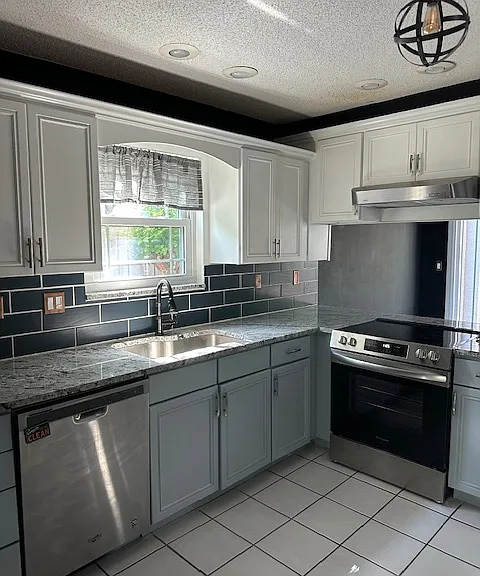 Updated kitchen with granite counter tops, new backsplash and stainless steel appliances.